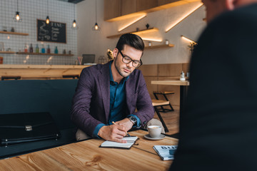 businessmen having meeting in cafe