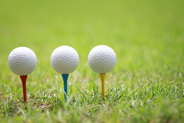 Golf ball on wooden golf tee.