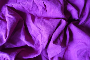 Folded simple plain bright violet linen fabric