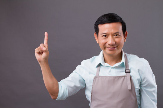 Confident Man Shopkeeper Pointing Up To Space, Concept Of Small Business Owner, Shop Manager, Entrepreneur Showing Or Suggesting Something