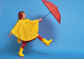child with red umbrella