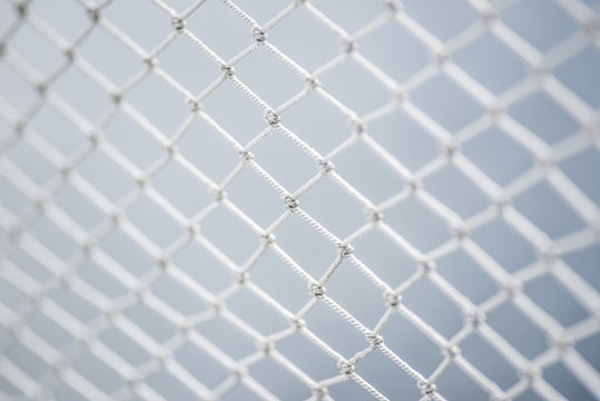 A material net that is a decoration on a yacht, performing protective functions. Texture or background.