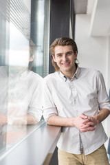 Fototapeta premium young businessman in startup office by the window