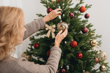 woman decorating christmas tree