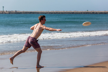 Teenager Boy Beach Frisbee Throwing