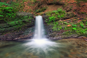 Falling water from the rock in the deep forest, nature landscape, Lumshory, Carpathians