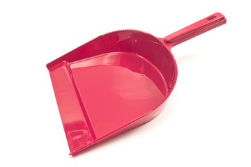 Red plastic dustpan scoop for cleaning isolated on white