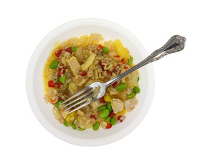 Top view of a rice with chicken and vegetables TV dinner in a bowl isolated on a white background.