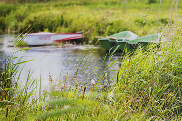 on the winding river stands several boats