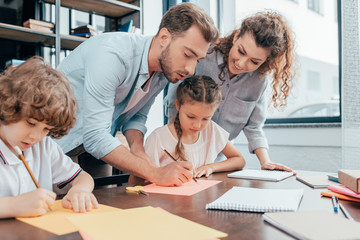 parents doing homework with adorable little kids
