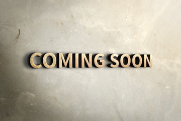 Coming soon wood sign on concrete wall near window with sun light,Business concept,3d rendering