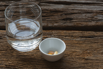 Medications and a glass of water