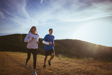 Woman running with her personal trainer