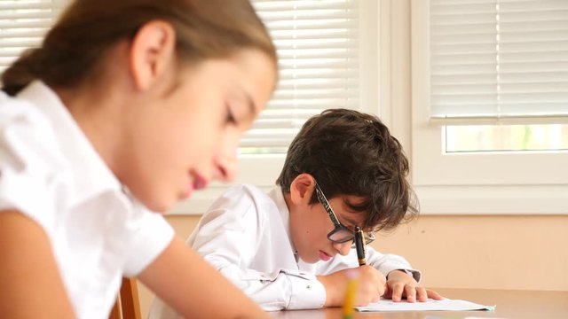 education, people and learning concept - group of students with notebooks writing test at school. 4k. Slow motion