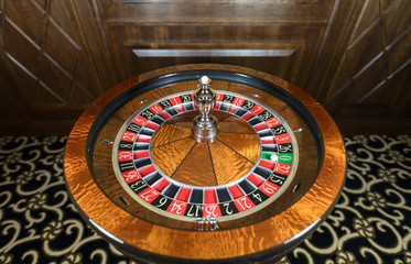 American Roulette wheel with a ball in the number '0'