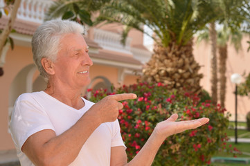 elderly man pointing 