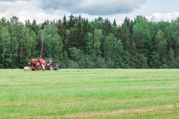 Tractor in a field mowing hay