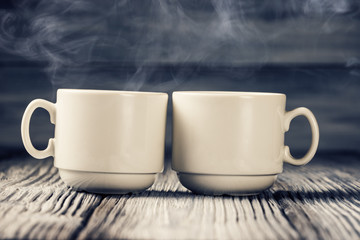 Two cups of coffee with steam