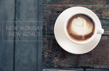 NEW MONDAY NEW GOALS Concept and Morning coffee on Wood background