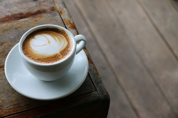 Hot coffee latte on wooden table morning.with space for your text