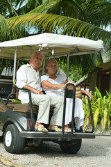 Elderly couple moving on cart