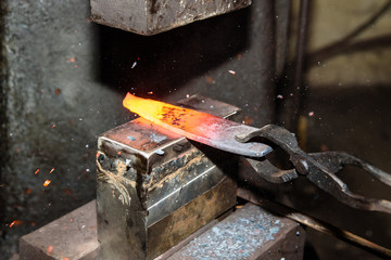 Forging molten metal. Making knives.