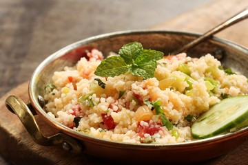 Tabbouleh Salad - Popular vegetarian Mediterranean dish made of fresh cucumber,tomatoes,parsley and coucous
