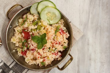 Tabbouleh Salad - Popular vegetarian Mediterranean dish made of fresh cucumber,tomatoes,parsley and coucous