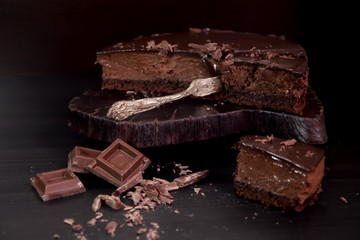 Chocolate mousse cake on dark background. Selective focus.