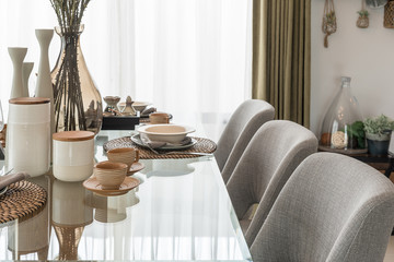 table set on glass dining table in modern dining room