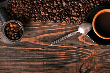 Coffee cup and coffee beans on wooden background. Top view.