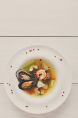 French seafood soup with white fish, shrimps and mussels in plat