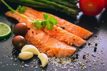 Delicious portion of fresh salmon fillet with salt and pepper