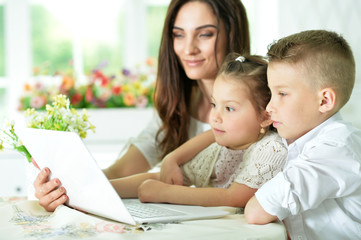 Mother and children with laptop