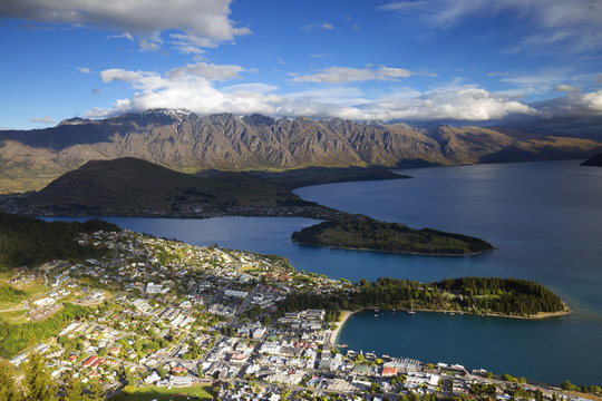 A vivid view of Queenstown with blue sky, beautiful lake and mountains.