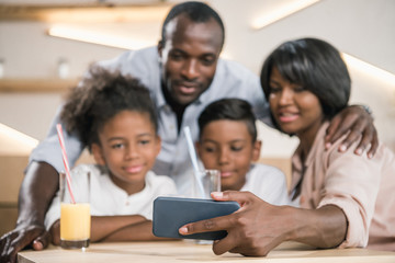 close-up shot of african-american family looking at phone