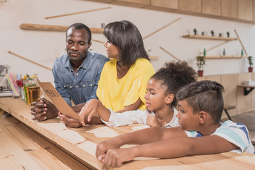 adorable african-american family in cafe at bar counter