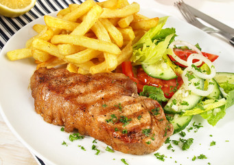 Schweinerückensteak mit Pommes Frites und Salat