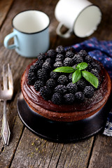 Dessert with nut biscuit, chocolate fondant and fresh blackberries.