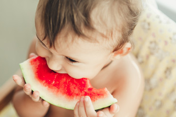 Little boy eating watermelon