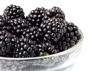 Closeup blackberries in a glass bowl.