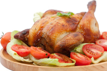 close up roast chicken on wooden plate  isolated on white