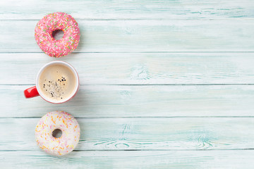 Fototapeta na wymiar Coffee cup and colorful donuts