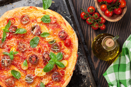 Pizza with tomatoes, mozzarella and basil