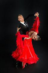 ballrom dance couple in a dance pose isolated on black background