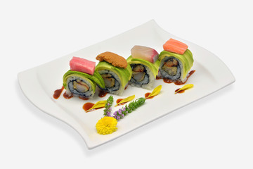 Avocado sushi rolls in white plate japanese style on white background