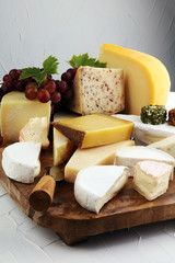 Cheese platter with different cheese and grapes