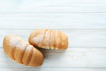 Fresh croissants on white wooden table