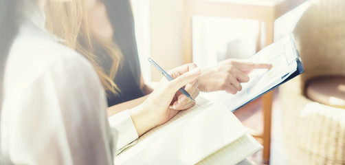 Project managers meeting.Business crew working with new startup,Teamwork concept,Two women discussion document in the office.collaborative filtering.Analyze plans.selective focus,vintage color