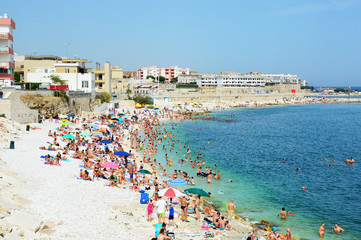 Very Crowded Beach Full Of People At The Mediterranean Sea in Apulia turist region, Bisceglie, Italy
